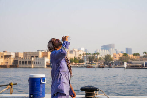A worker drinks water during a heatwave in Dubai, United Arab Emirates