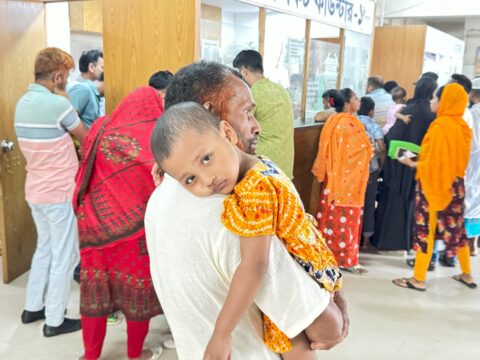 A child suffering from pneumonia during the heatwave waits with his parents for test results at Dhaka Shishu (Children’s) Hospital
