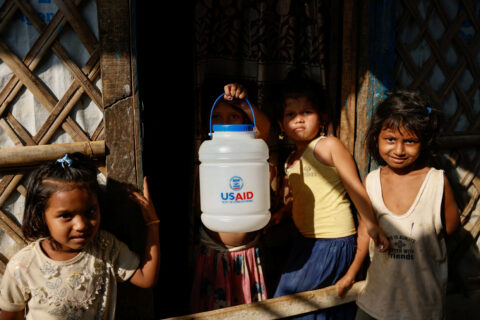 A Rohingya refugee girl holds a jar with USAID logo imprinted, at the refugee camp in Cox's Bazar, Bangladesh, March 16, 2025. REUTERS/Mohammad Ponir Hossain