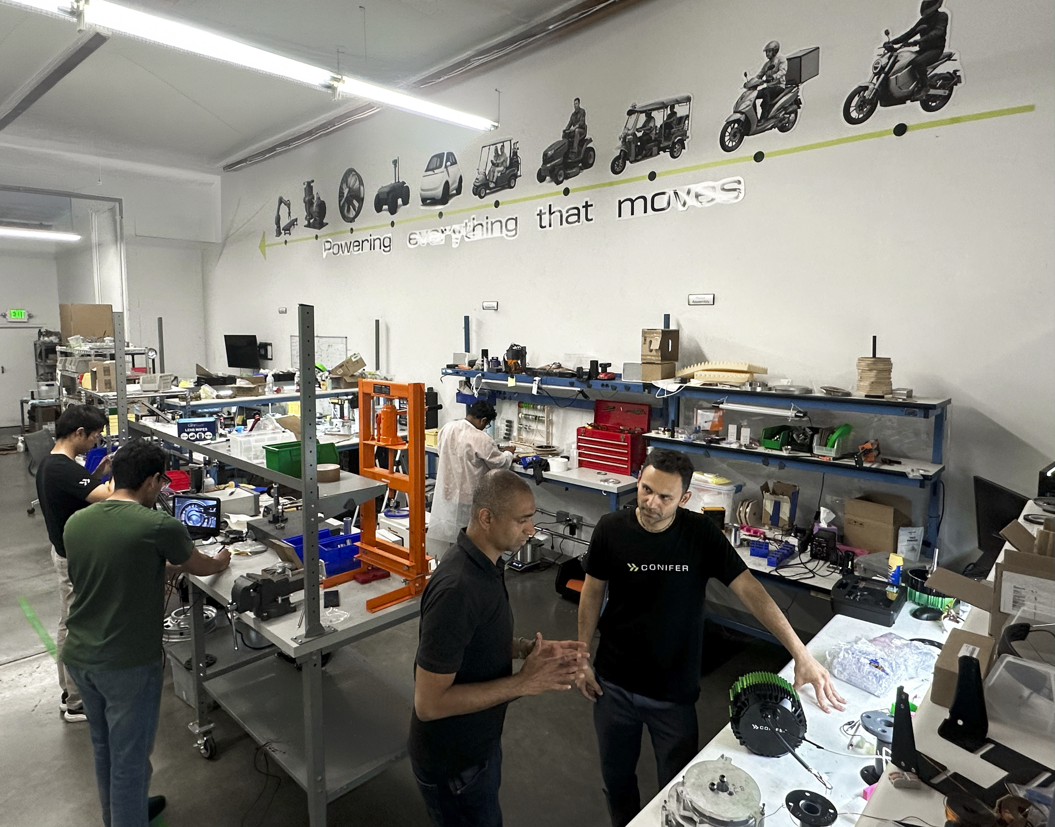 Conifer's Ankit Somani and an employee talk in the firm's R&D facility where staff is working on hardware